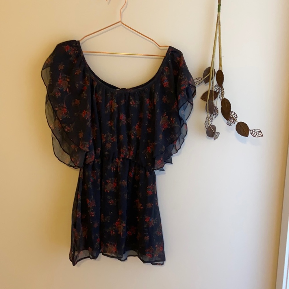 Black tunic with red wildflowers pattern.